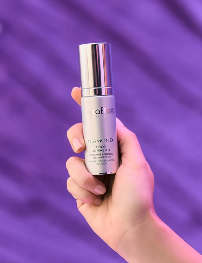 Hand holding Natura Bissé's Diamond Glyco Extreme Peel. Skincare product featured in bestsellers.
