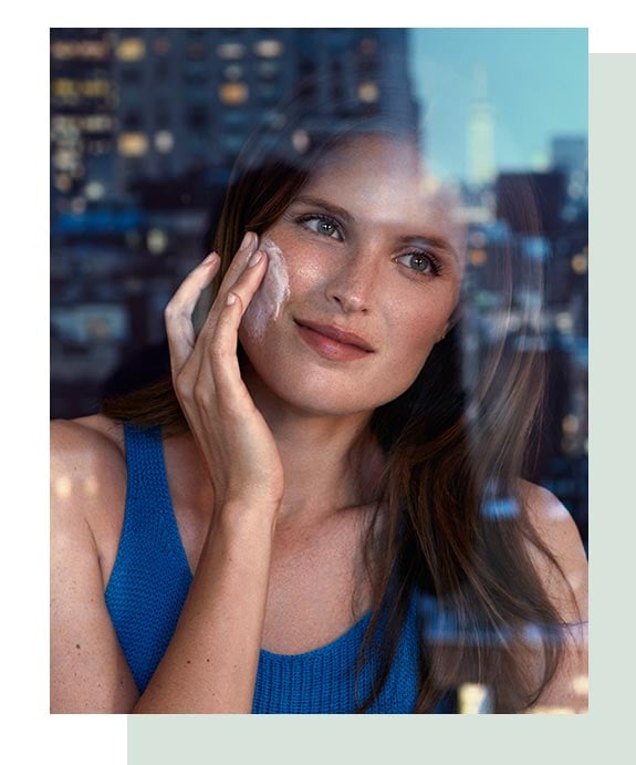 Woman applying facial cleanser